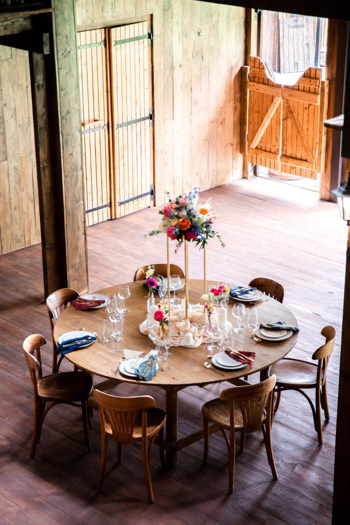 Table de mariage décorée avec fleurs colorées dans une grange en bois